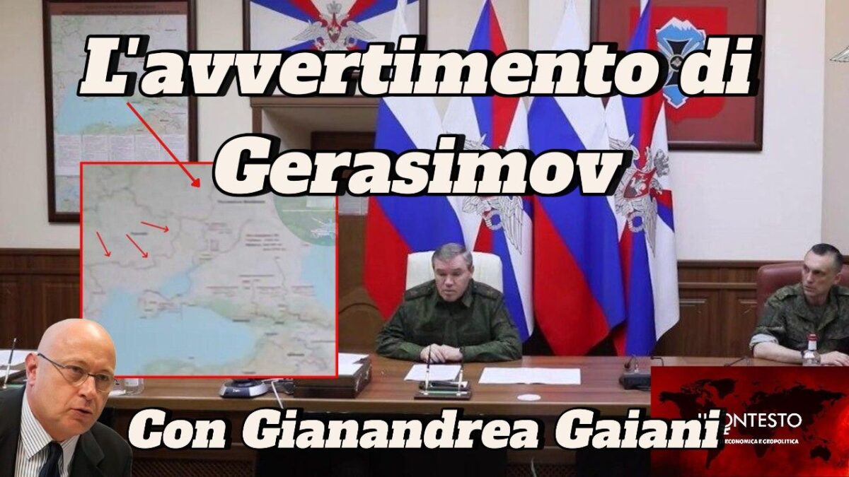 Tre ufficiali militari, seduti a un tavolo con mappe e bandiere, discutono dell'avvertimento di Gerasimov.